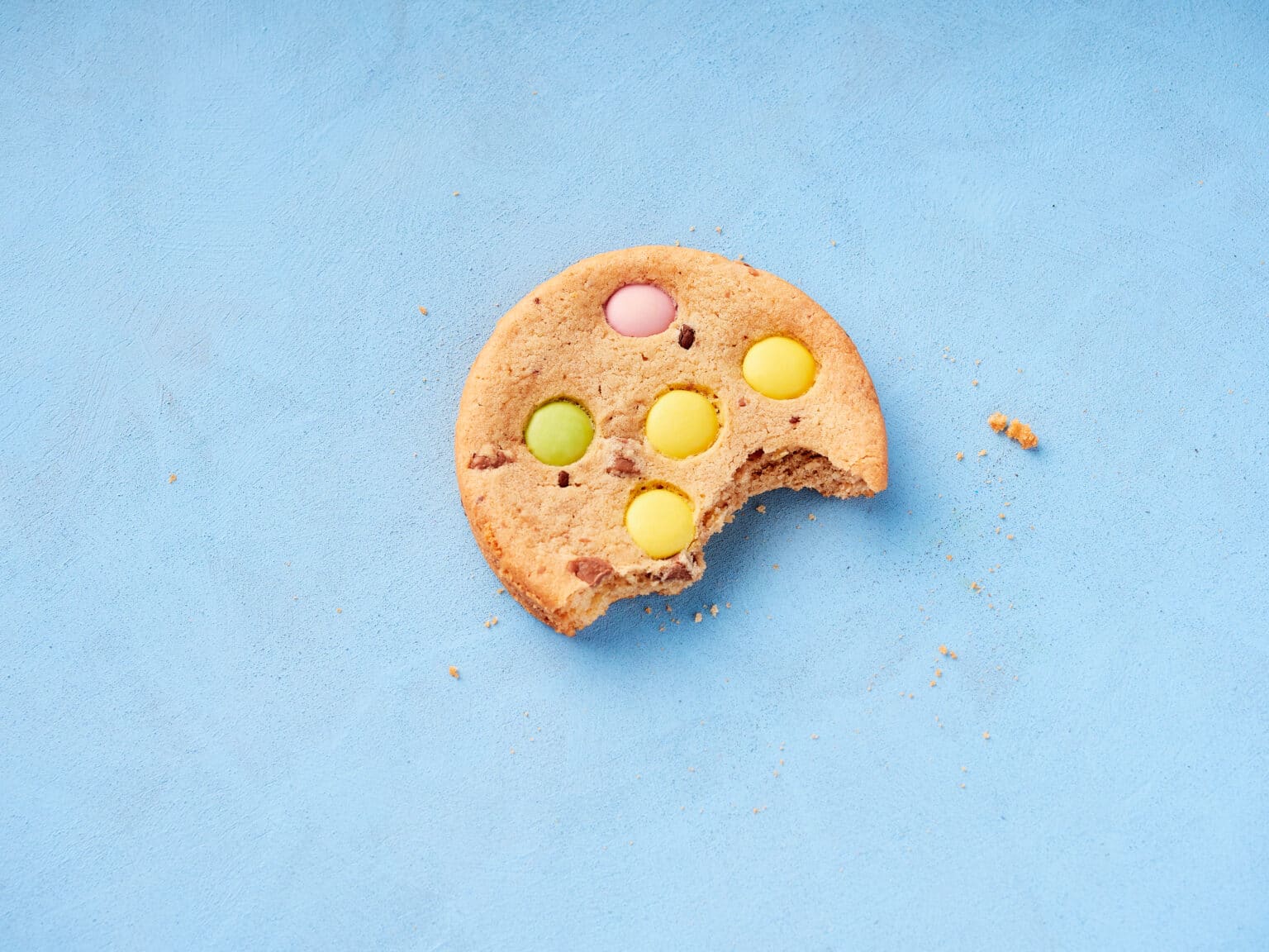 129 isolated cookie with a bite on an blue background